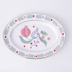 Decorative plate with pomegranate and leaf design on a white background