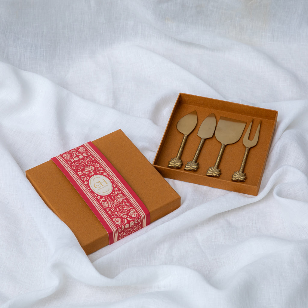 A Stainless Steel set of 4 - Palm Cheese knive set with a matte Brass finish. Sold as a set of 4 in a gift box.