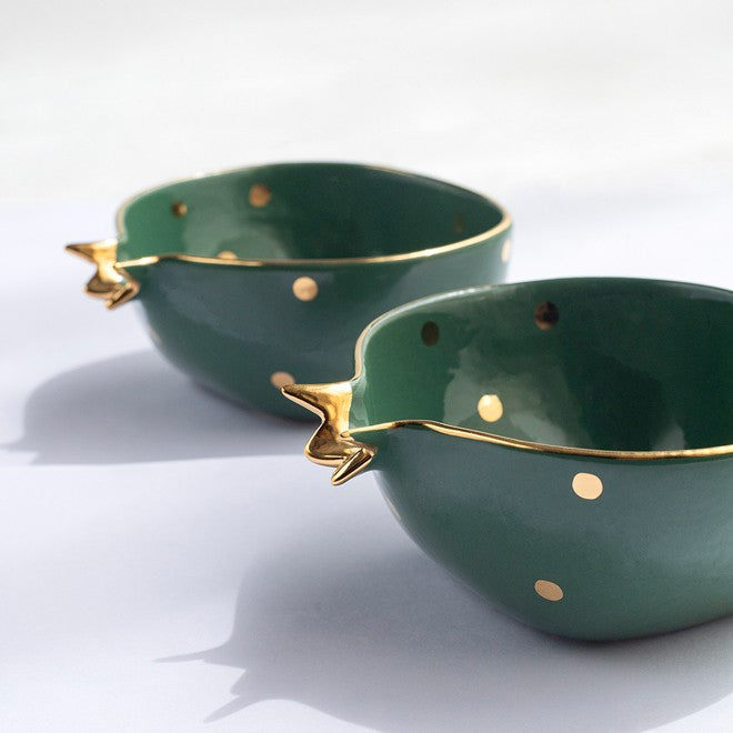 Two pomegranate shaped green ceramic bowls with gold accents